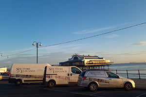 The Shutters of Elegance vans in front of Cleethorpes Pier at sunrise