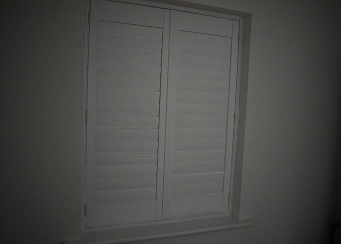 Blackout Shutters in a Child's Bedroom, showing one panel open with the pleated blind visible